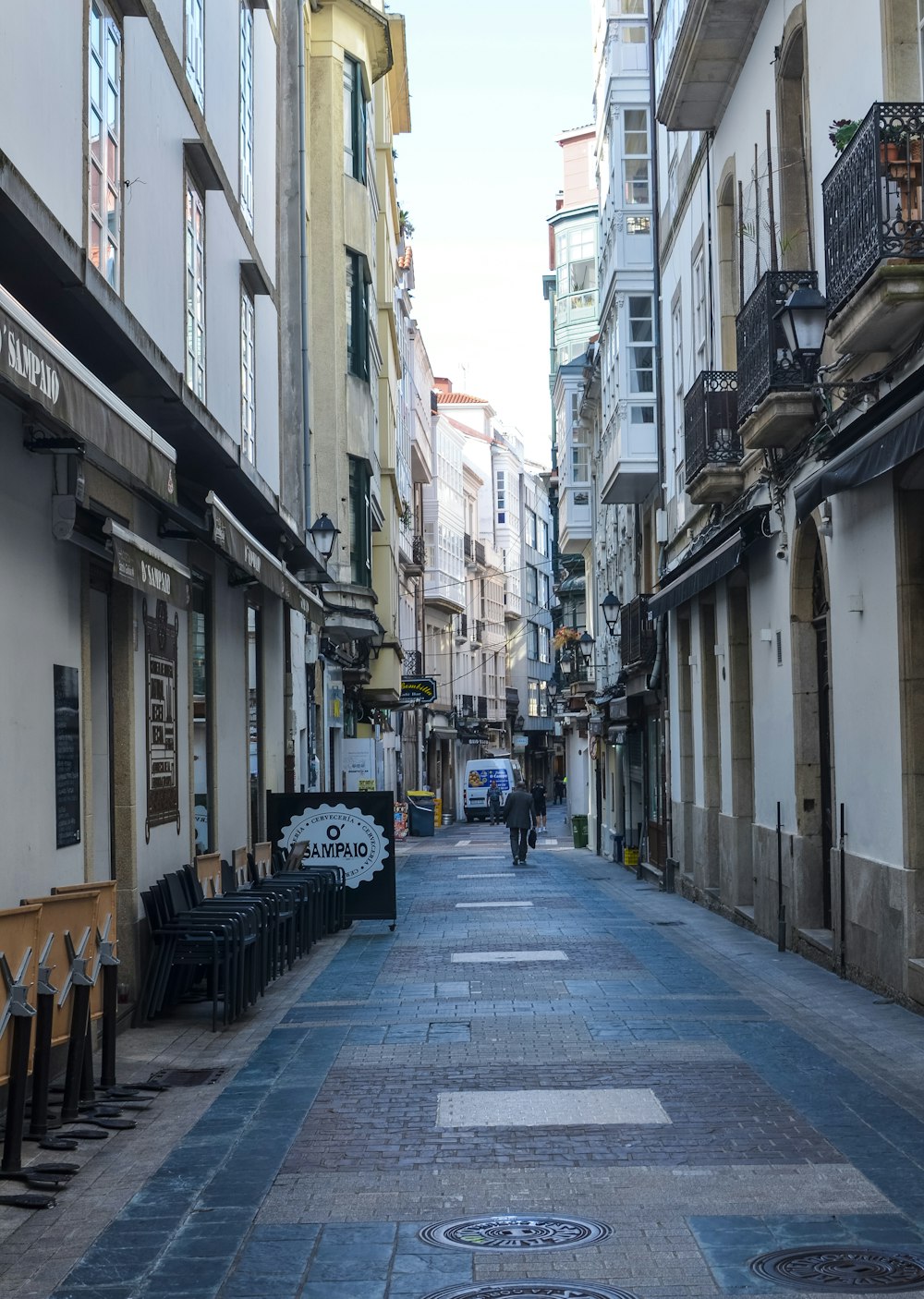 uma pessoa andando por uma rua estreita