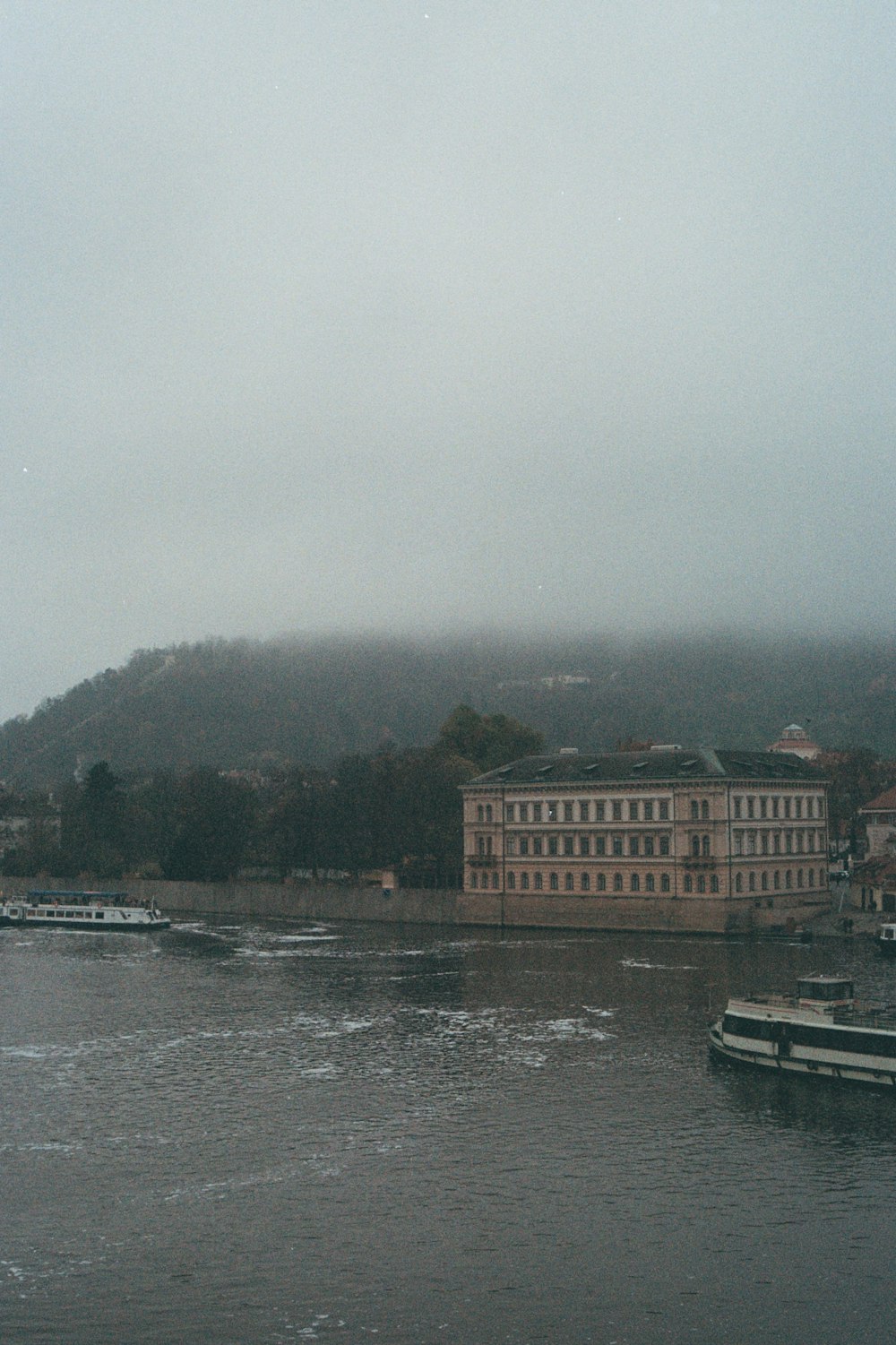 a body of water with boats and buildings along it