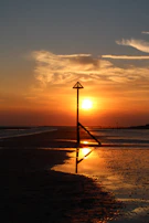 A bright sunset over a peaceful beach, symbolizing tranquility.