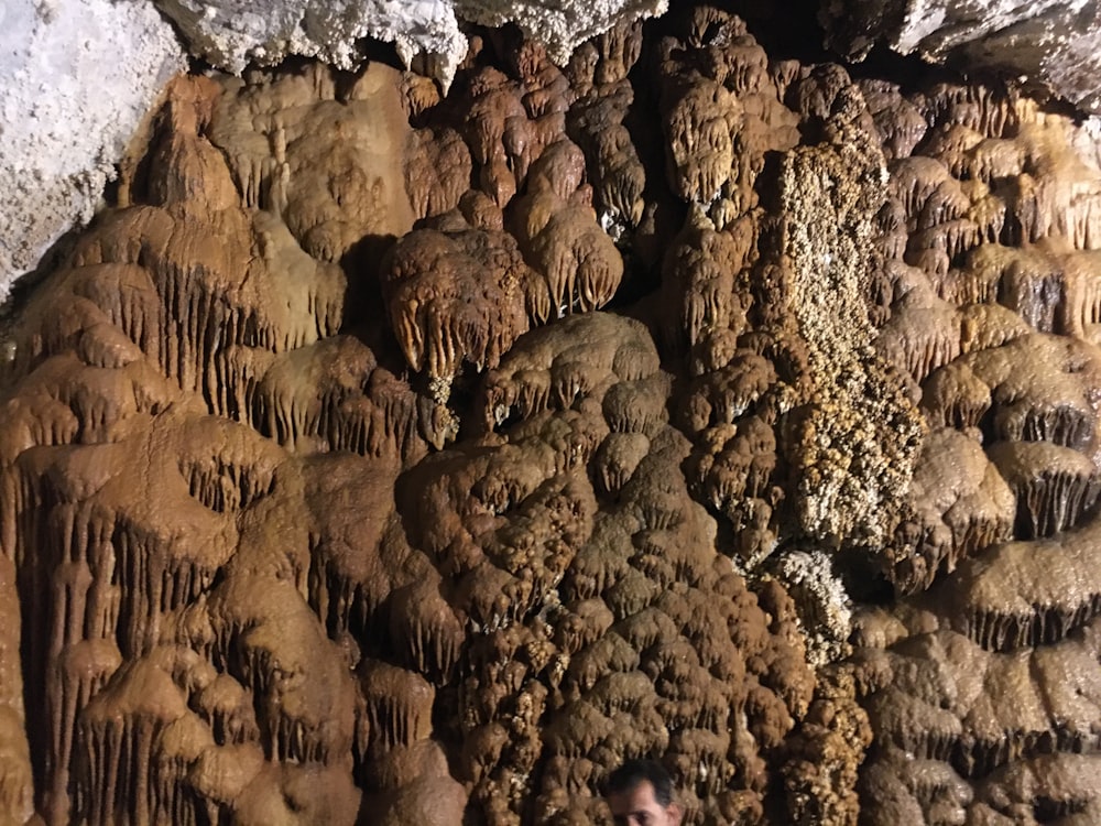 a group of people standing in a rocky area