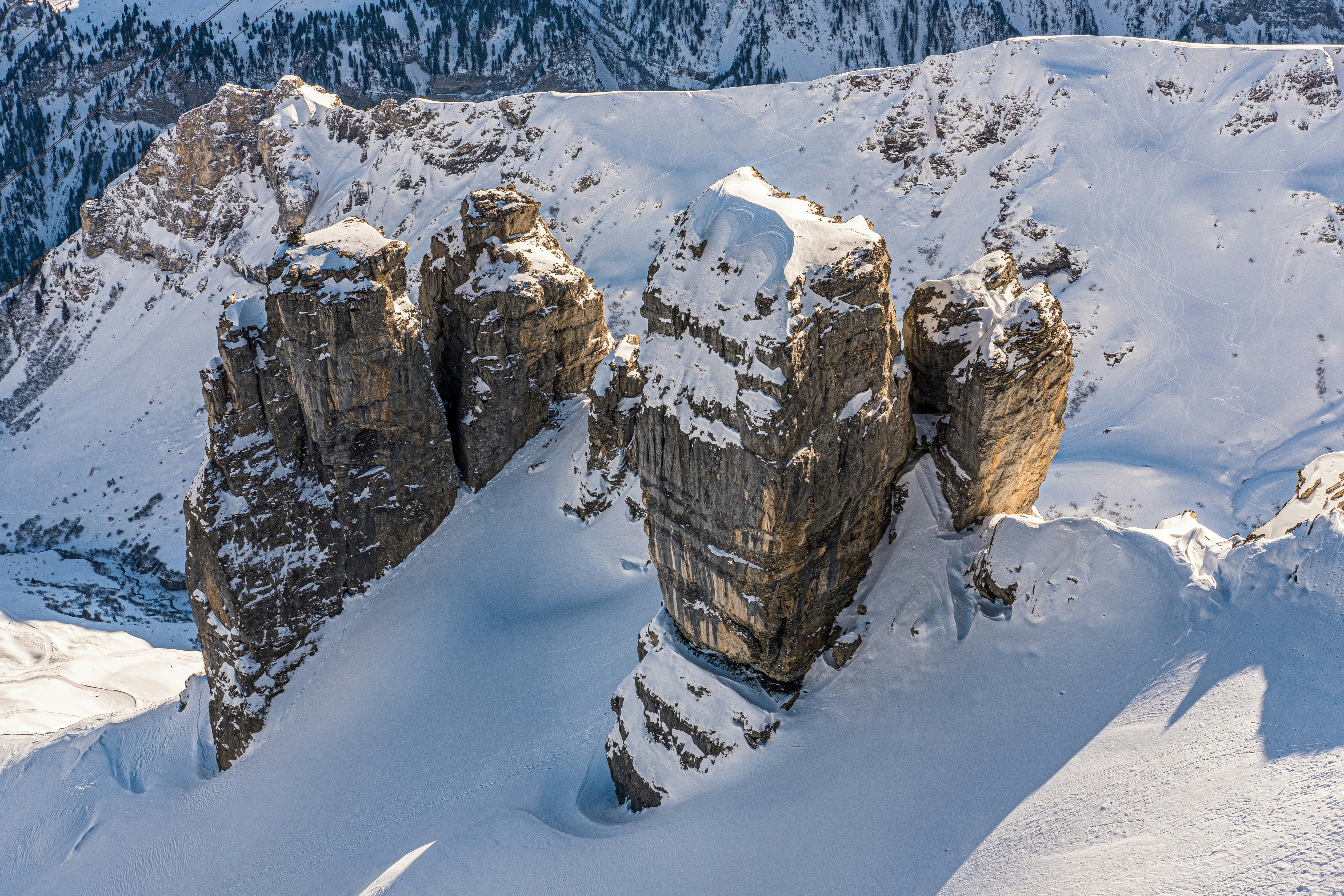 a group of large rocks in the snow