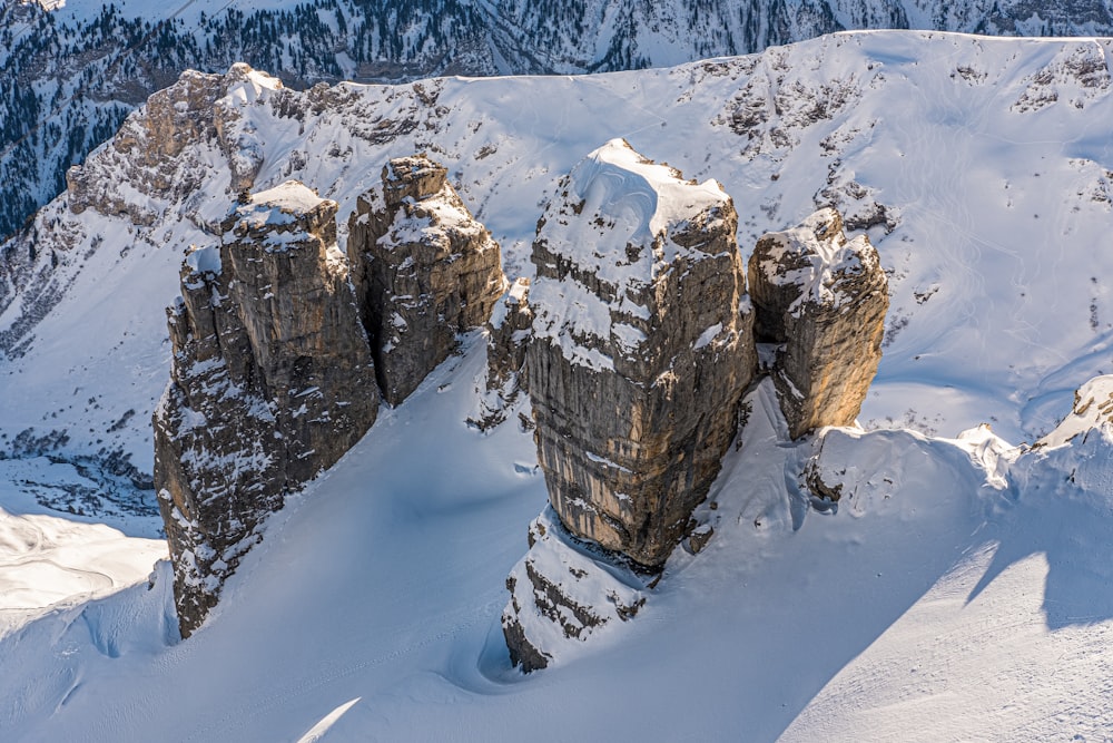 a group of large rocks in the snow