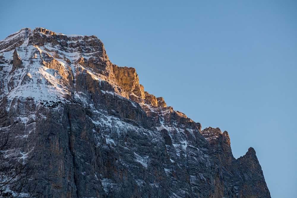 a rocky mountain with snow