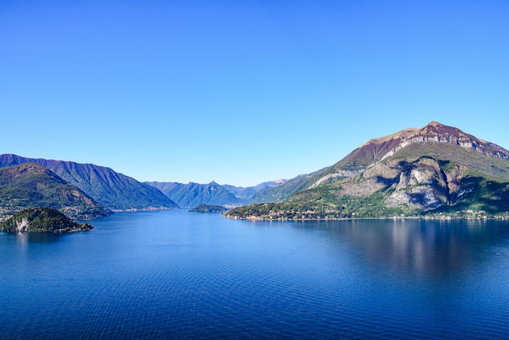 a body of water with mountains in the background