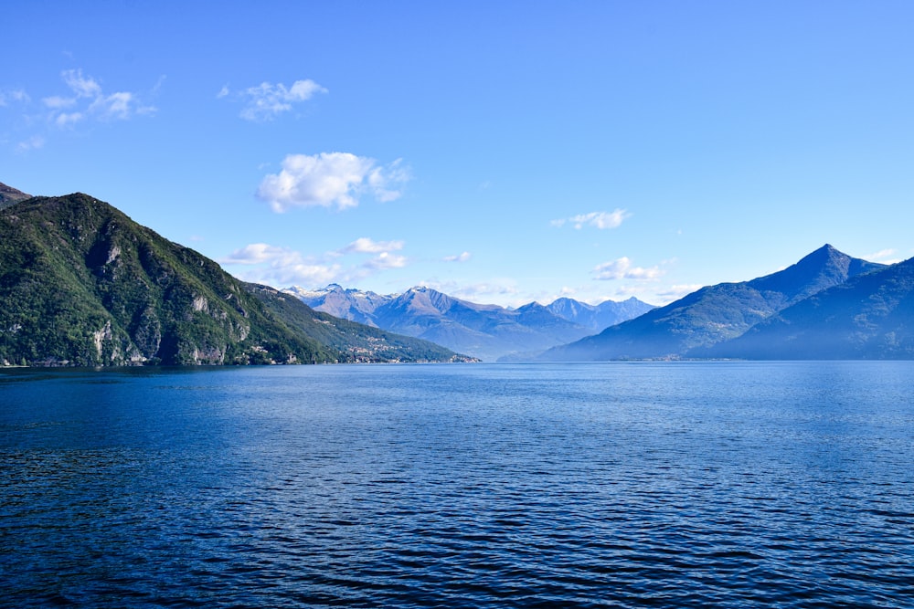 a body of water with mountains in the background