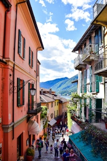 a group of people walking down a street between buildings