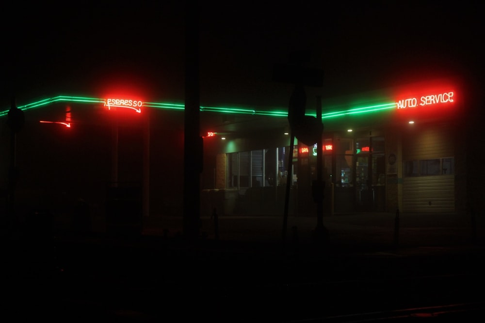 a person standing in front of a building with green lights