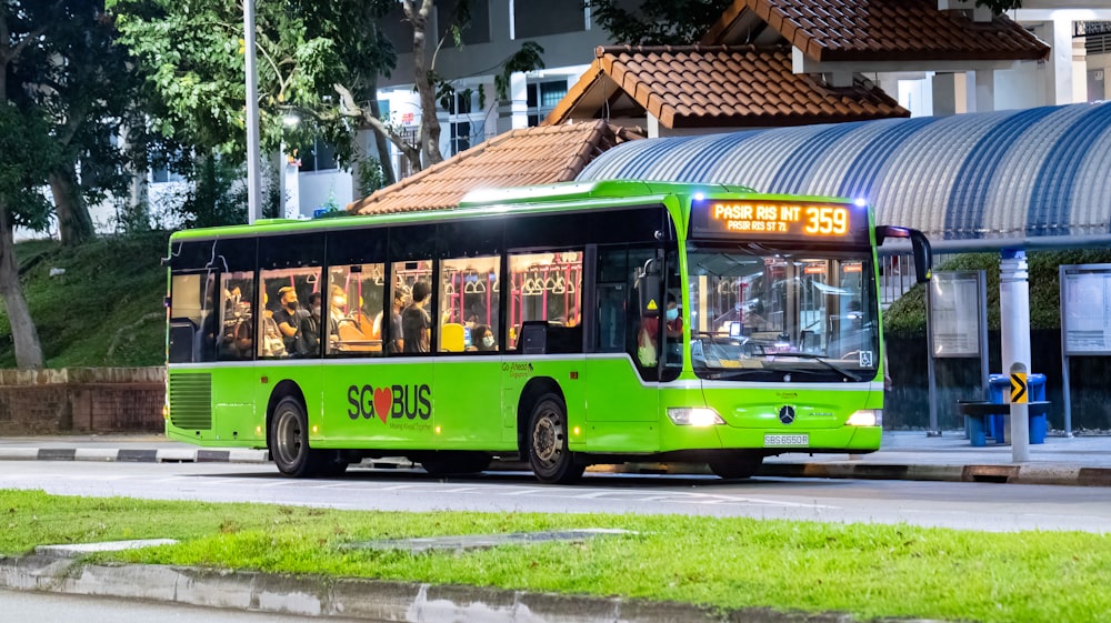 a green bus on the street