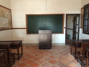 A welcoming classroom with desks and a whiteboard ready for English lessons.