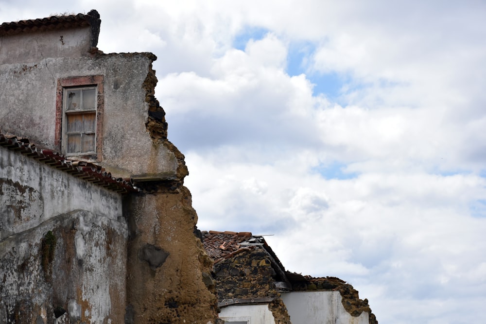 a building with a window and a cloudy sky