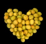 Illustration of colorful fruits and vegetables arranged in a heart shape