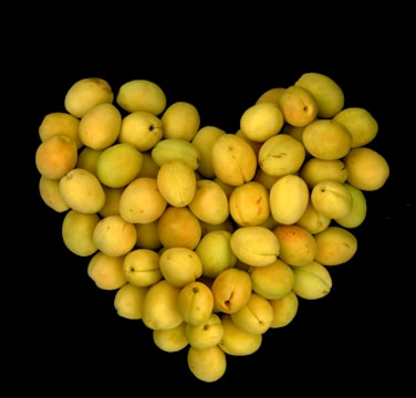 Illustration of colorful fruits and vegetables arranged in a heart shape