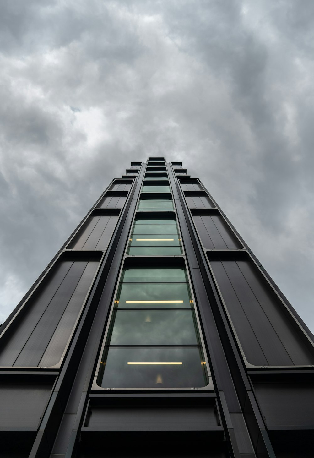 a tall building with a cloudy sky