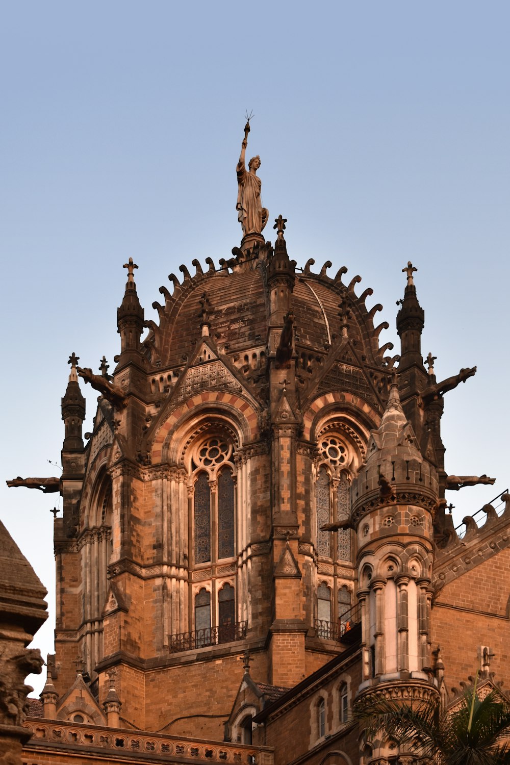 a large building with a statue on top