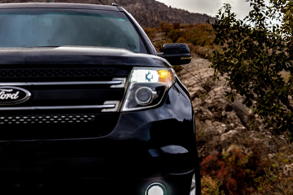 a black car on a dirt road