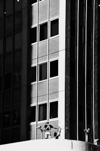 A sleek black and white image of a modern home inspection in progress.