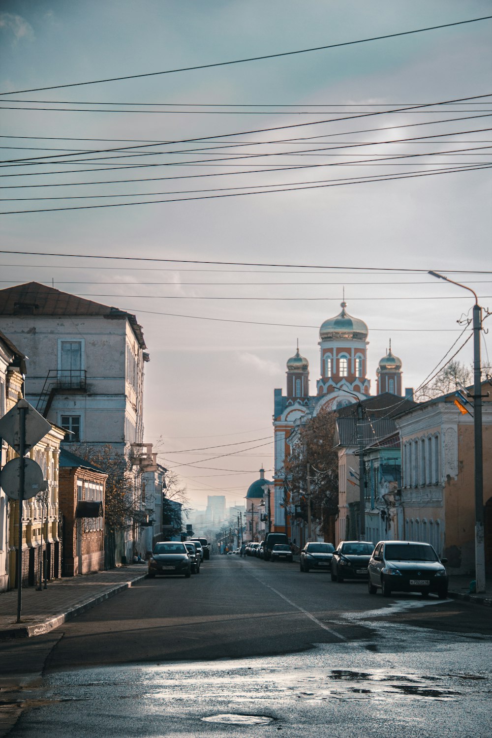 a street with cars on it and buildings on the side