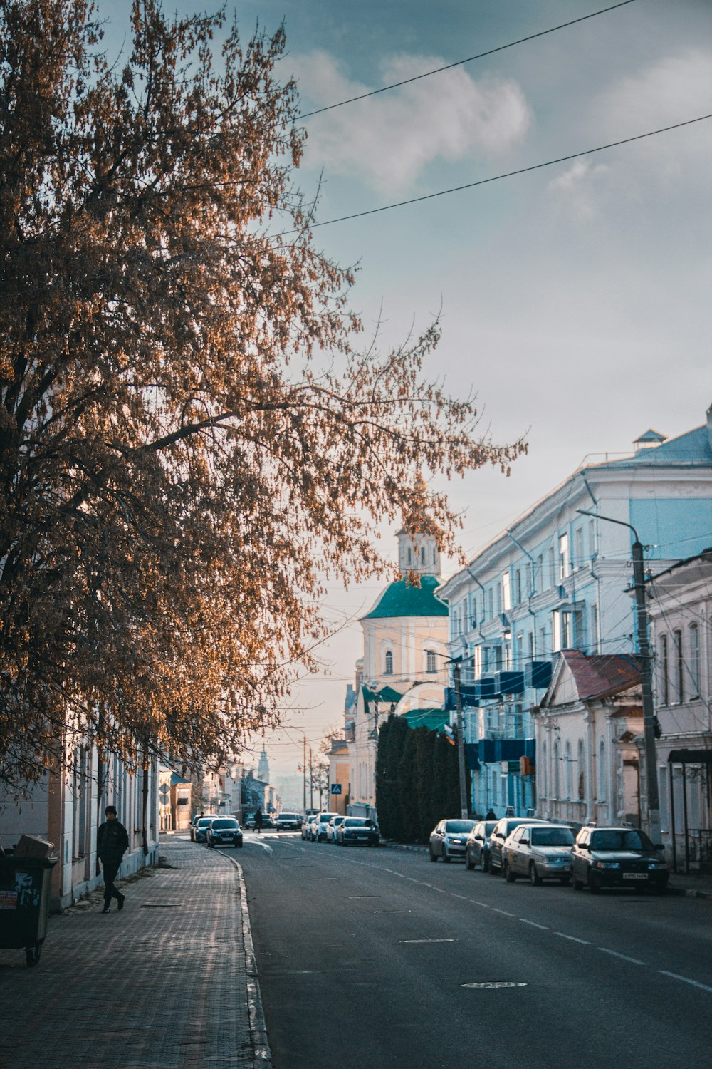 a street with cars and buildings along it