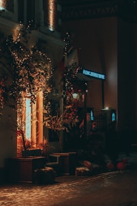Cozy nighttime storefront of a 24-hour beverage shop with warm lights and inviting entrance.