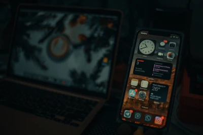 a cell phone next to a laptop