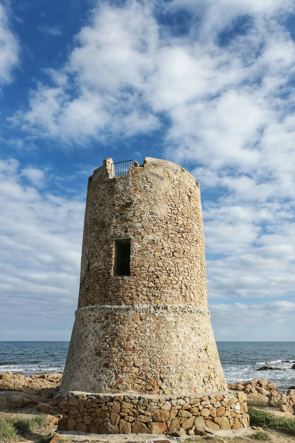 a stone tower on a beach