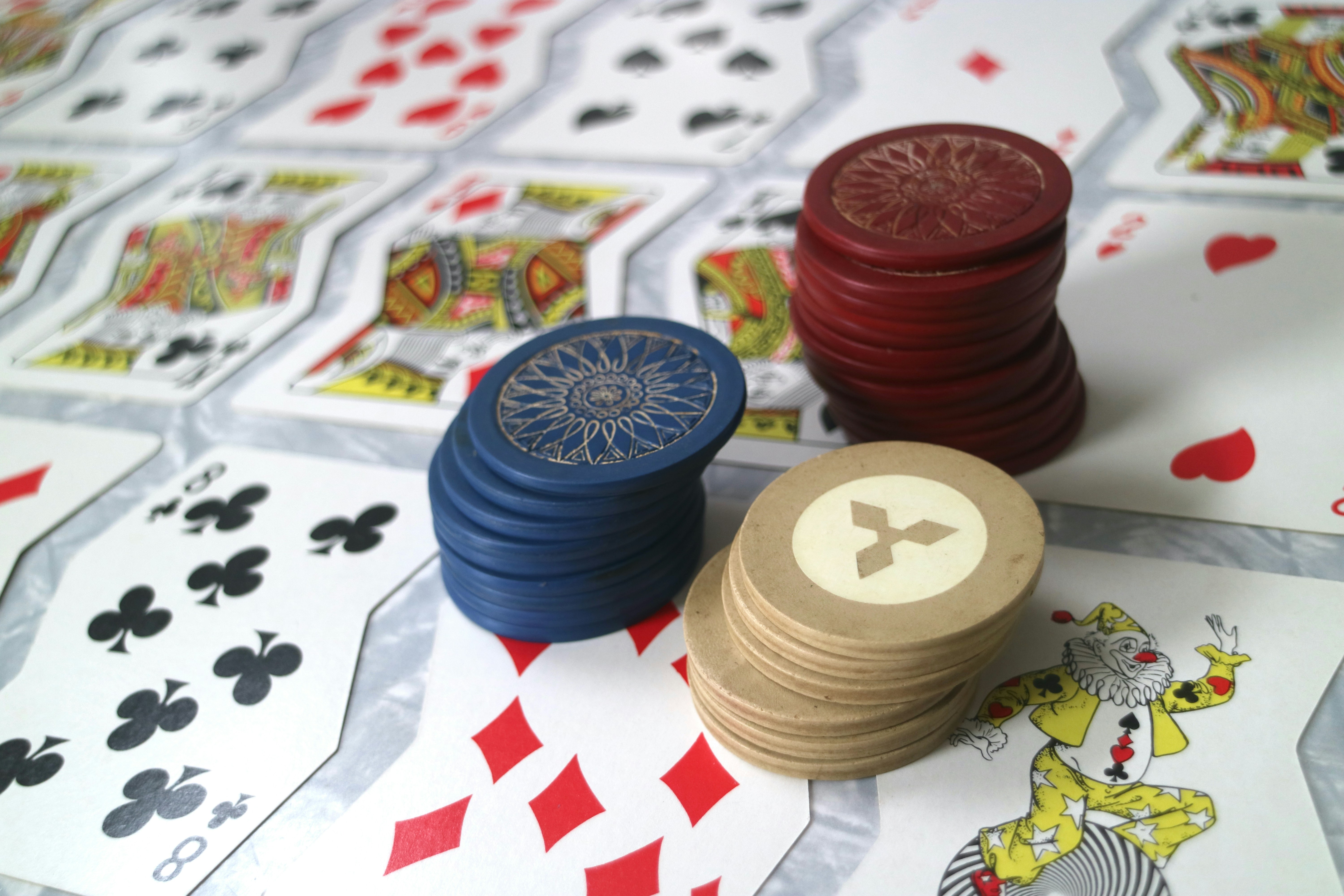 Some unusually shaped playing cards with poker chips.