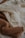 A collection of knitted sweaters in beige and cream colors, overlapping each other. The textures are prominently ribbed and feature a cozy pattern.