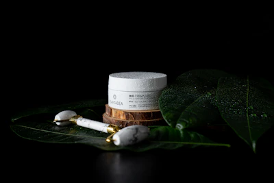 A sleek jar of luxury anti-aging cream resting on a marble countertop with soft gold accents.