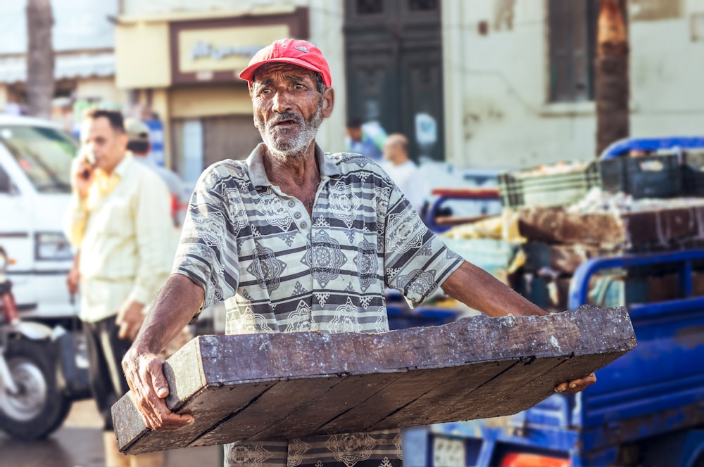 a man holding a large wheel