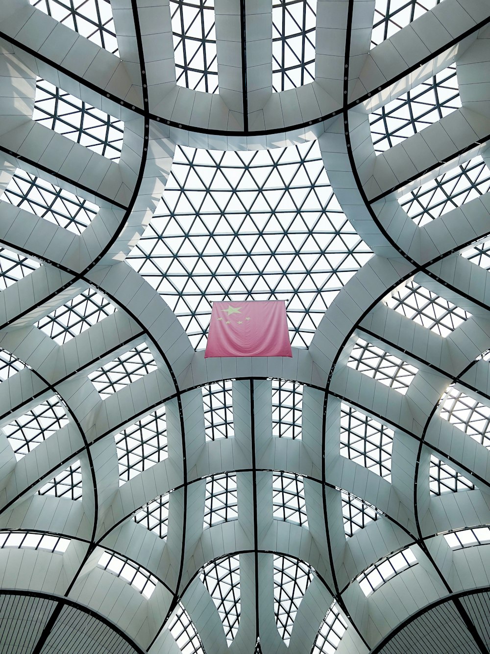 a large glass ceiling with a pink paper from the ceiling