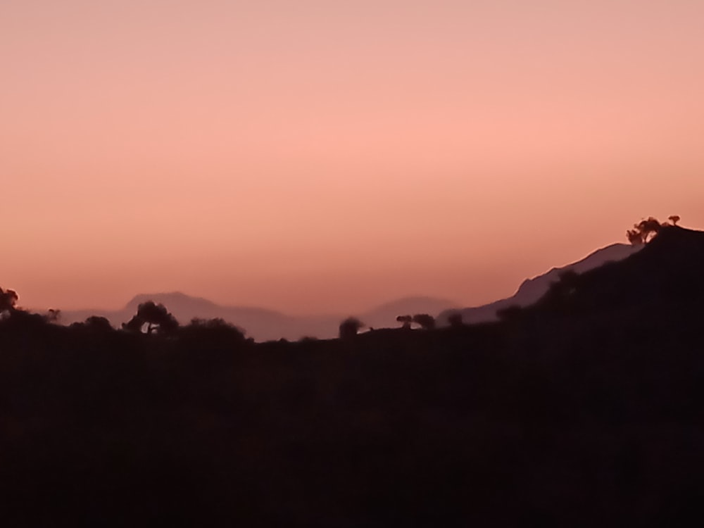 a sunset over a mountain