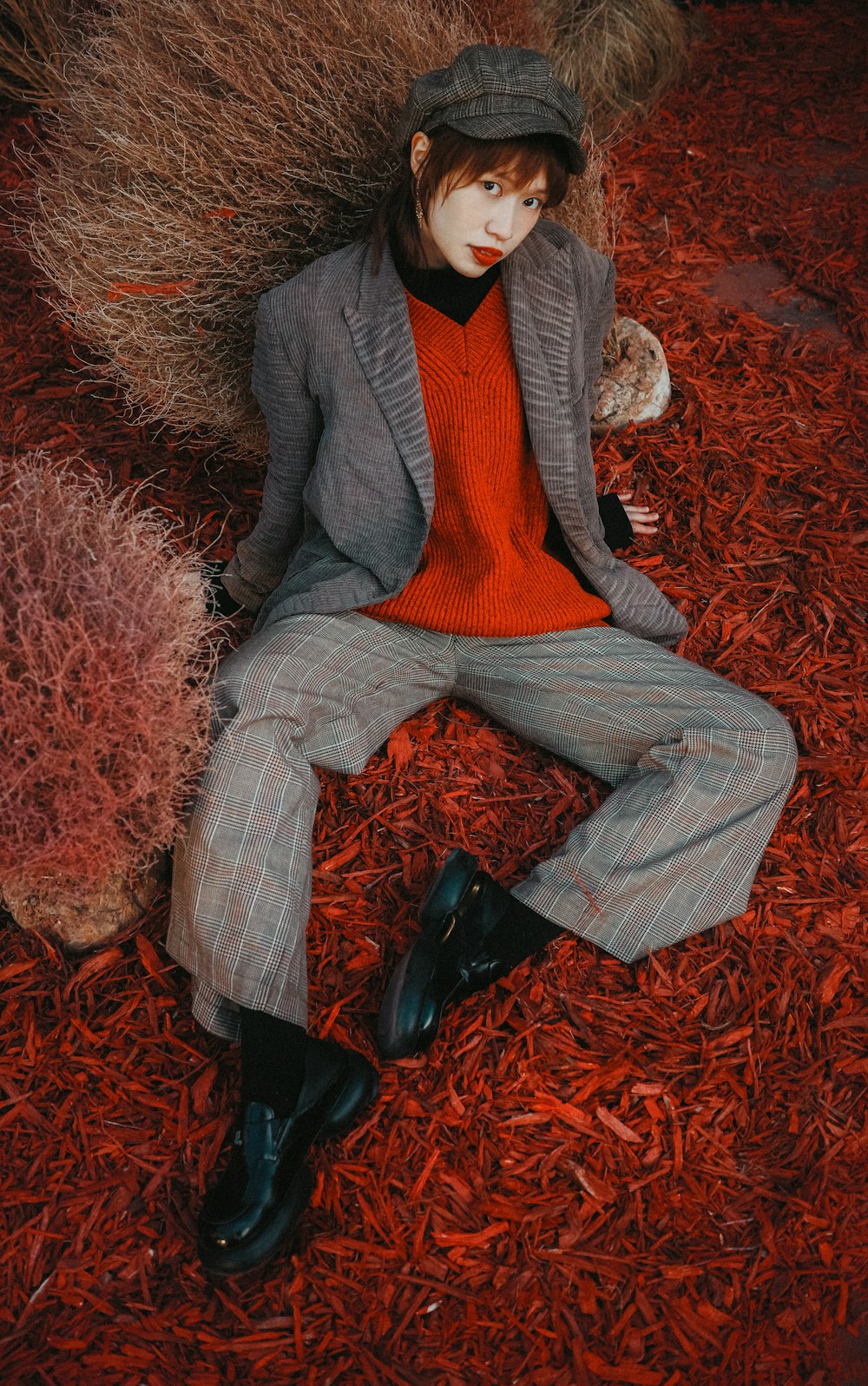 a person sitting on a red carpet