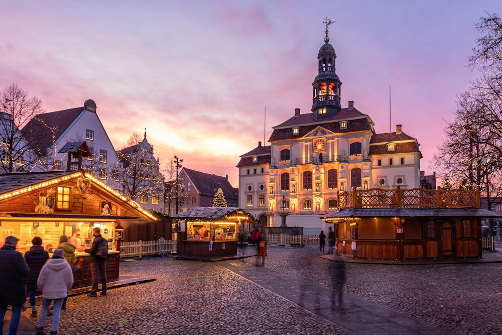 a group of people walking around a town square