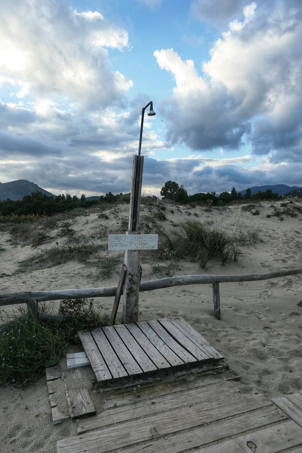 a wooden bridge over a sandy area