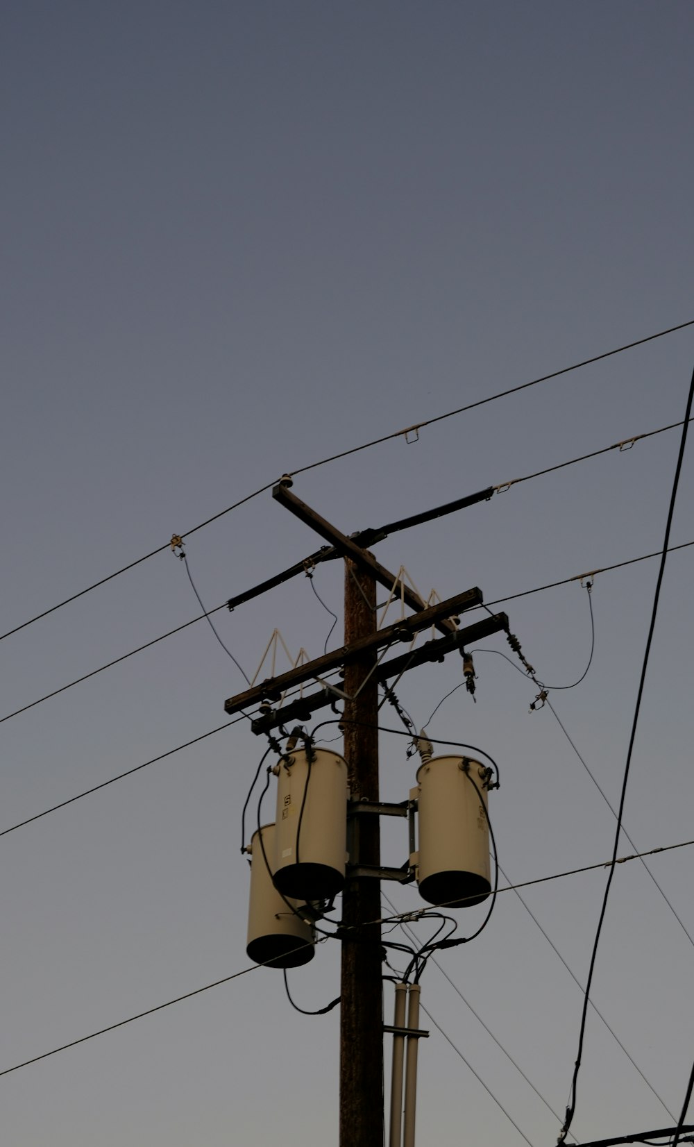 a telephone pole with many wires