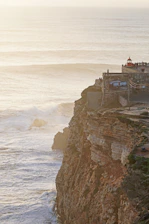 a building on a cliff above the ocean