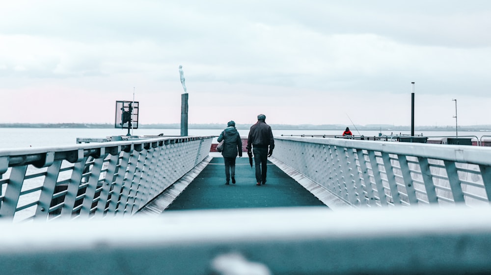 a couple walking on a bridge