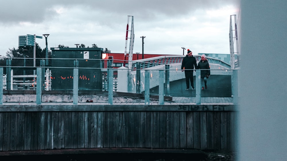 a group of men standing on a bridge