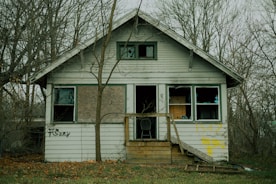 a white house with trees around it
