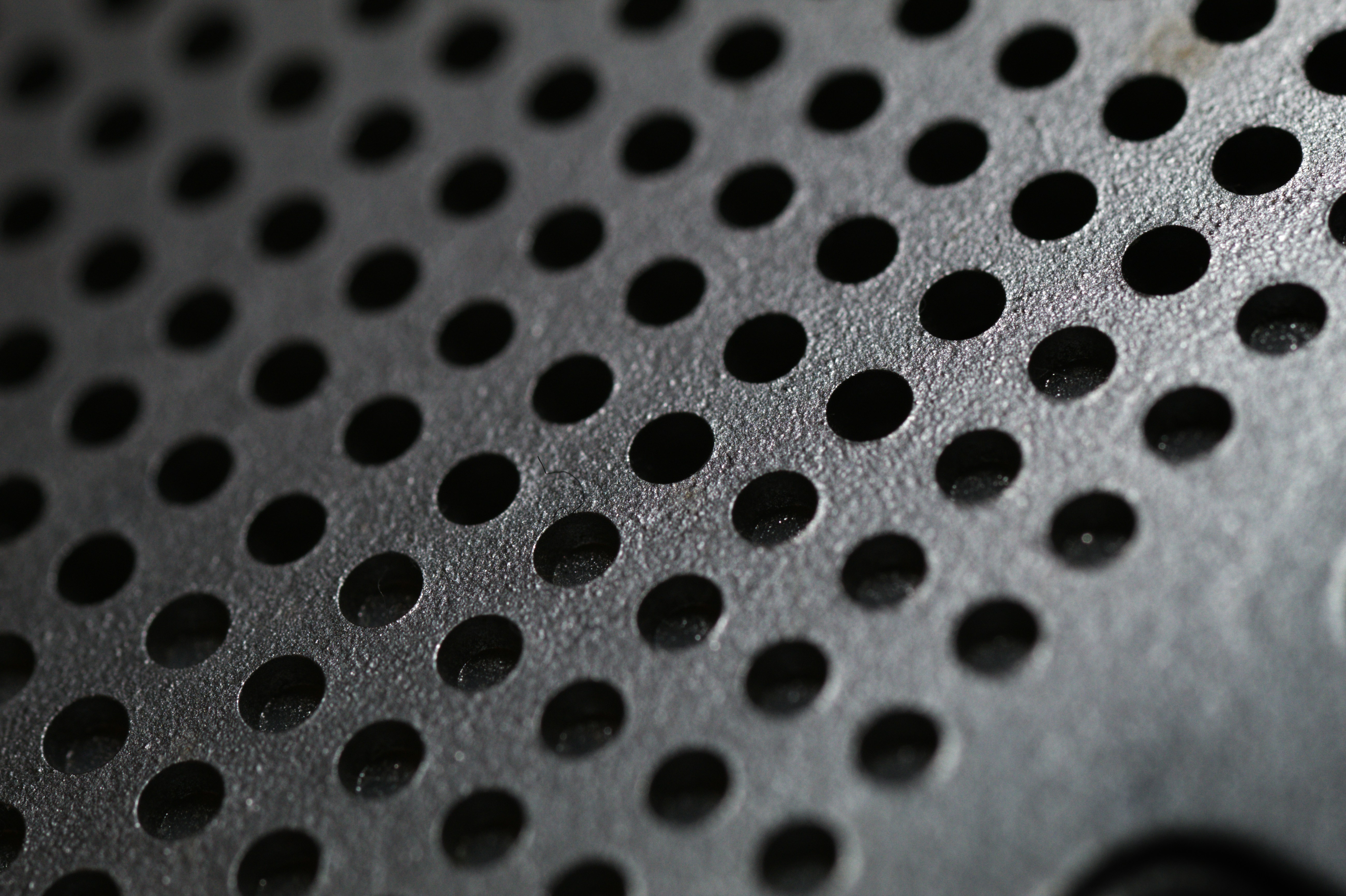 a close up of the surface of a portable plastic speaker