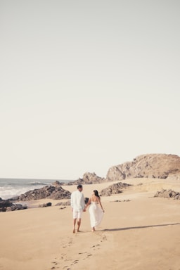 the journey ahead,how to photograph a man and woman walking on a beach