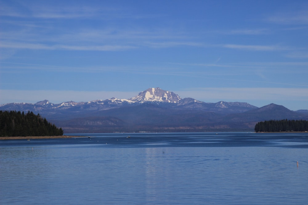 a body of water with mountains in the background