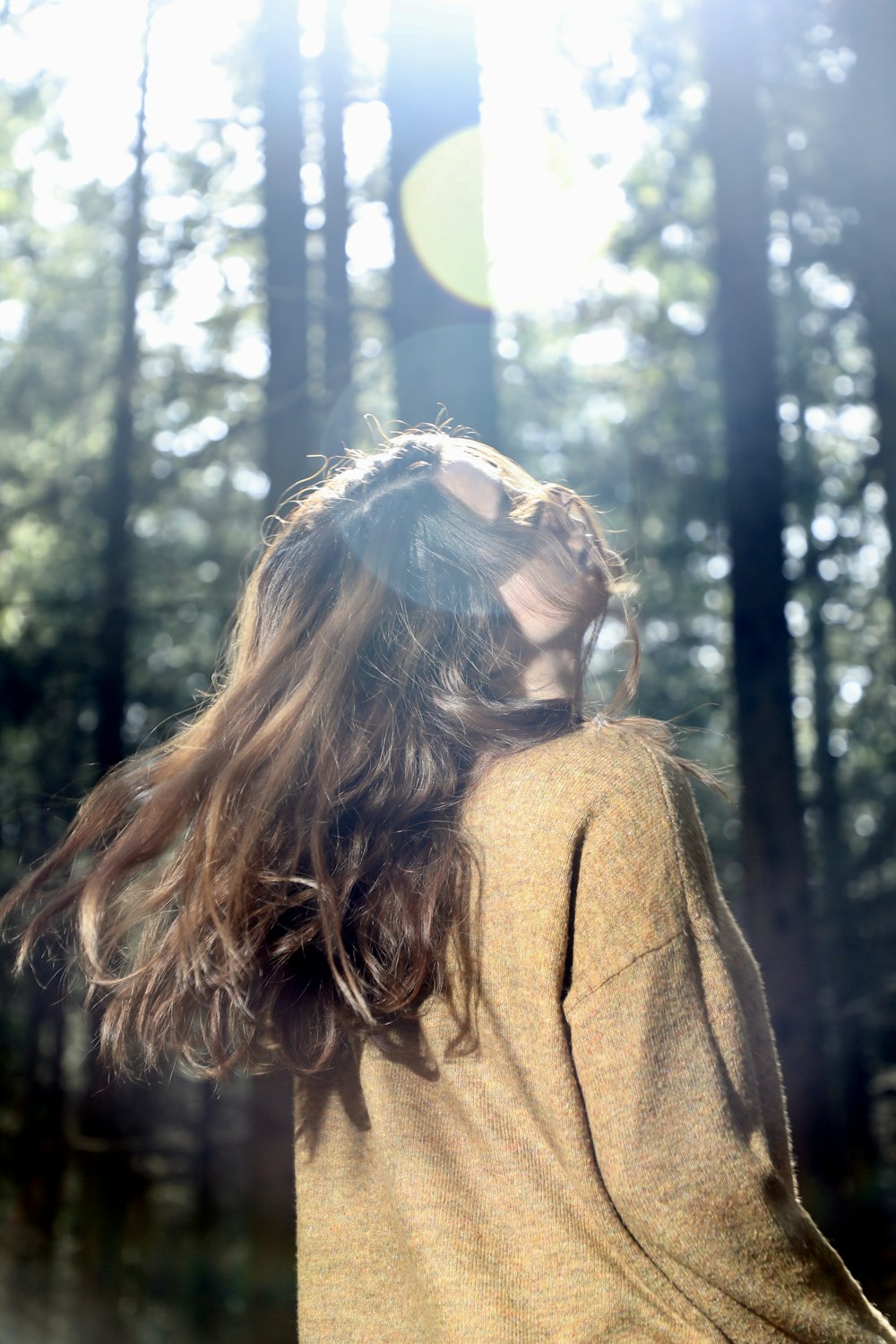 a person with the hair blowing in the wind