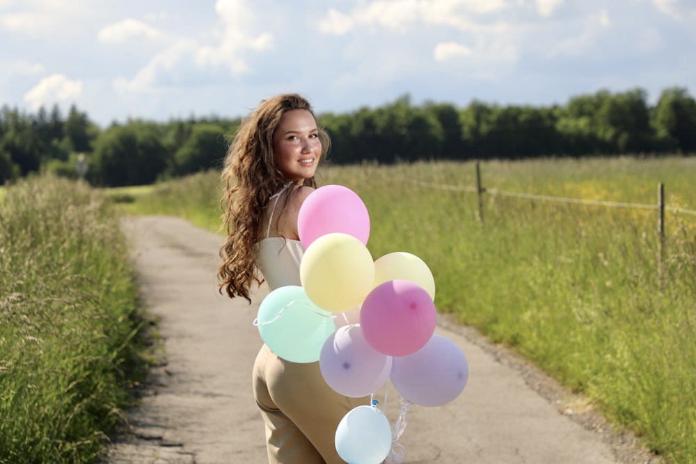 a person holding a bunch of balloons