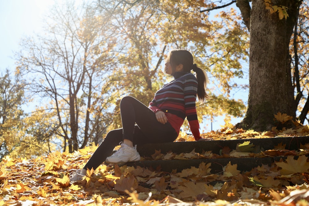 a person sitting on a log