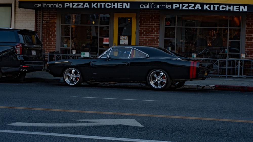 a black car parked on the side of a street