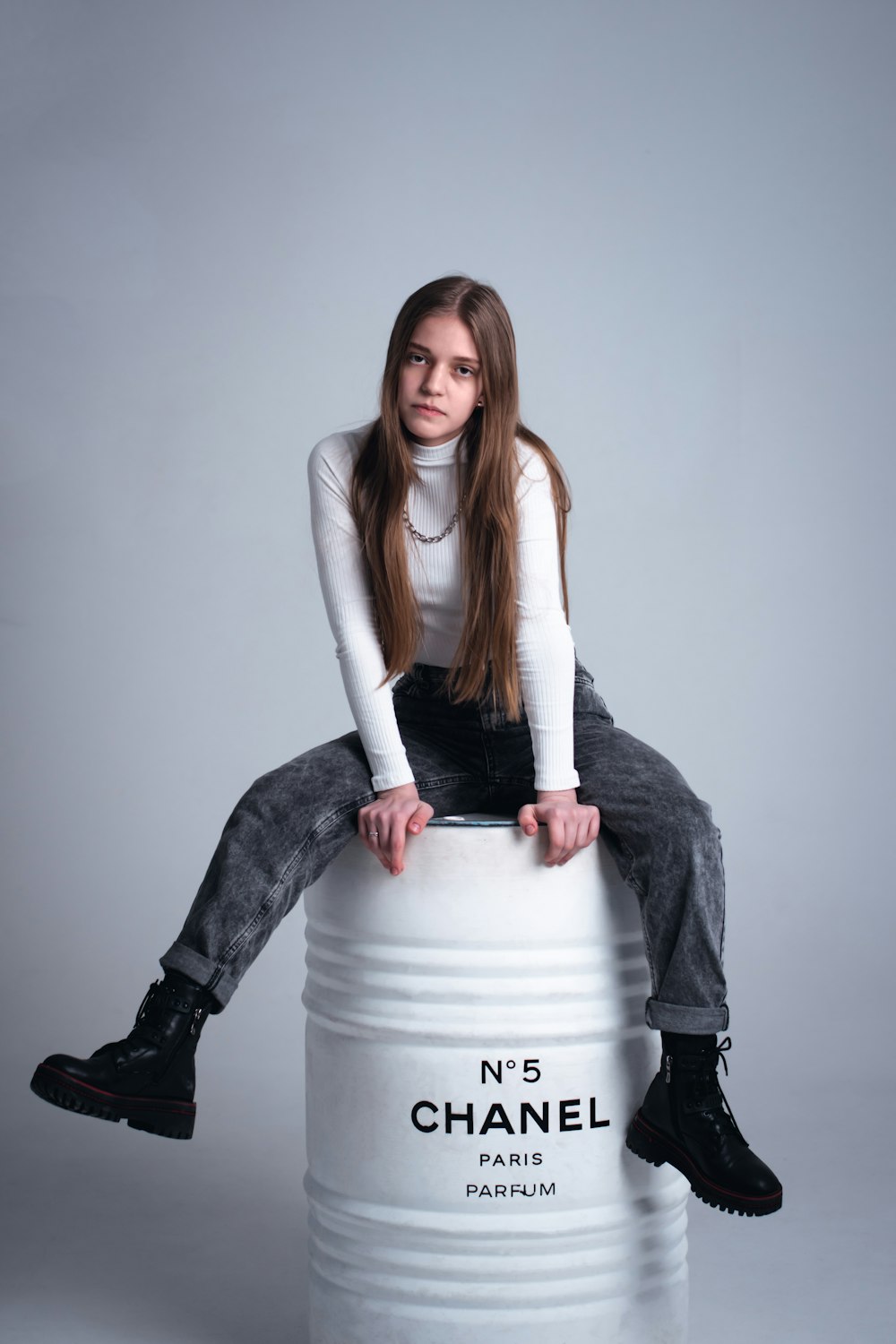 a person sitting on a large metal cylinder