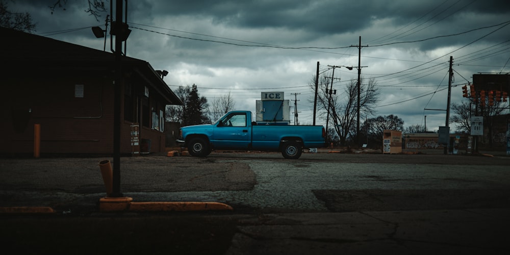 a blue truck parked on the side of a street