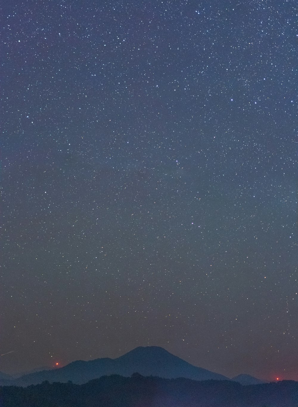 a mountain under a starry sky