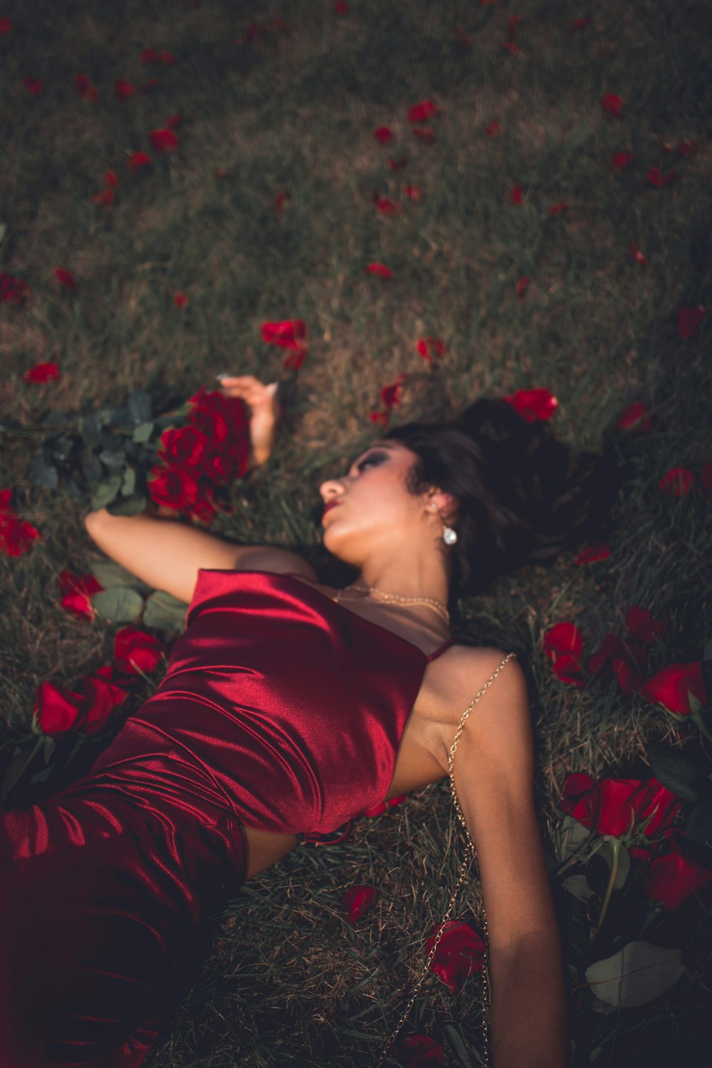 a man lying on the ground with flowers in his hair